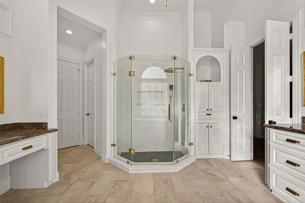 a large white kitchen with a window a sink stainless steel appliances and cabinets