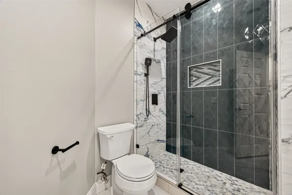 a bathroom with a sink a toilet and a mirror