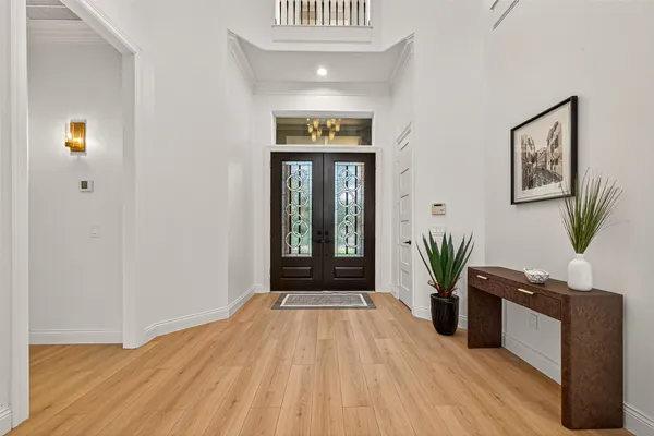 a view of a room with wooden floor and windows