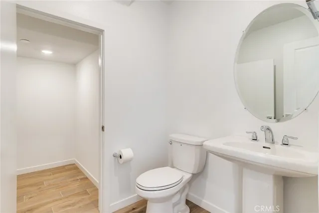 a bathroom with a sink a toilet and a mirror