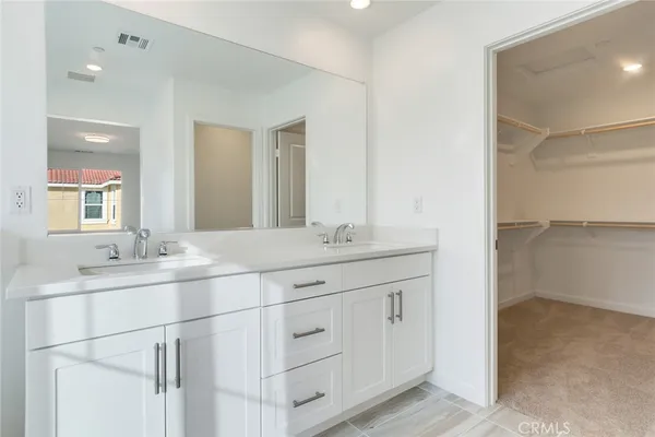 a bathroom with a double vanity sink and mirror