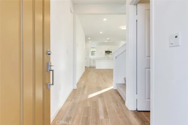 a view of a hallway with wooden floor