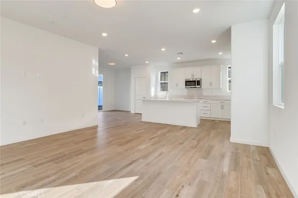 a view of kitchen with wooden floor and window