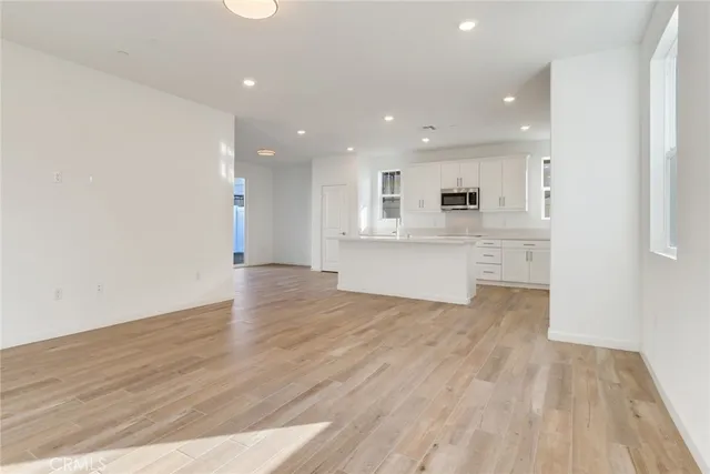 a view of kitchen with wooden floor and window