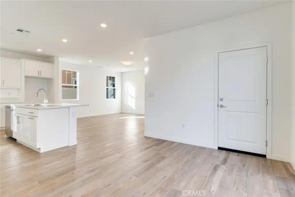 a view of kitchen with furniture and wooden floor