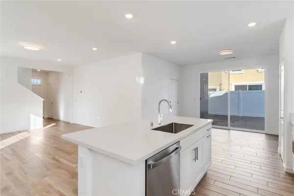 a kitchen with a sink and a refrigerator