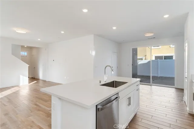 a kitchen with a sink and a refrigerator