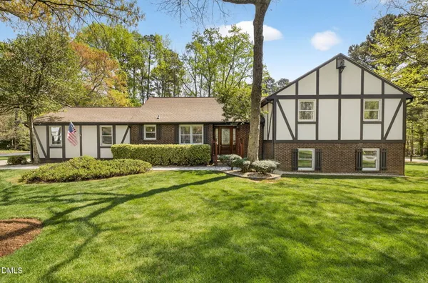 a view of a house with backyard and sitting area