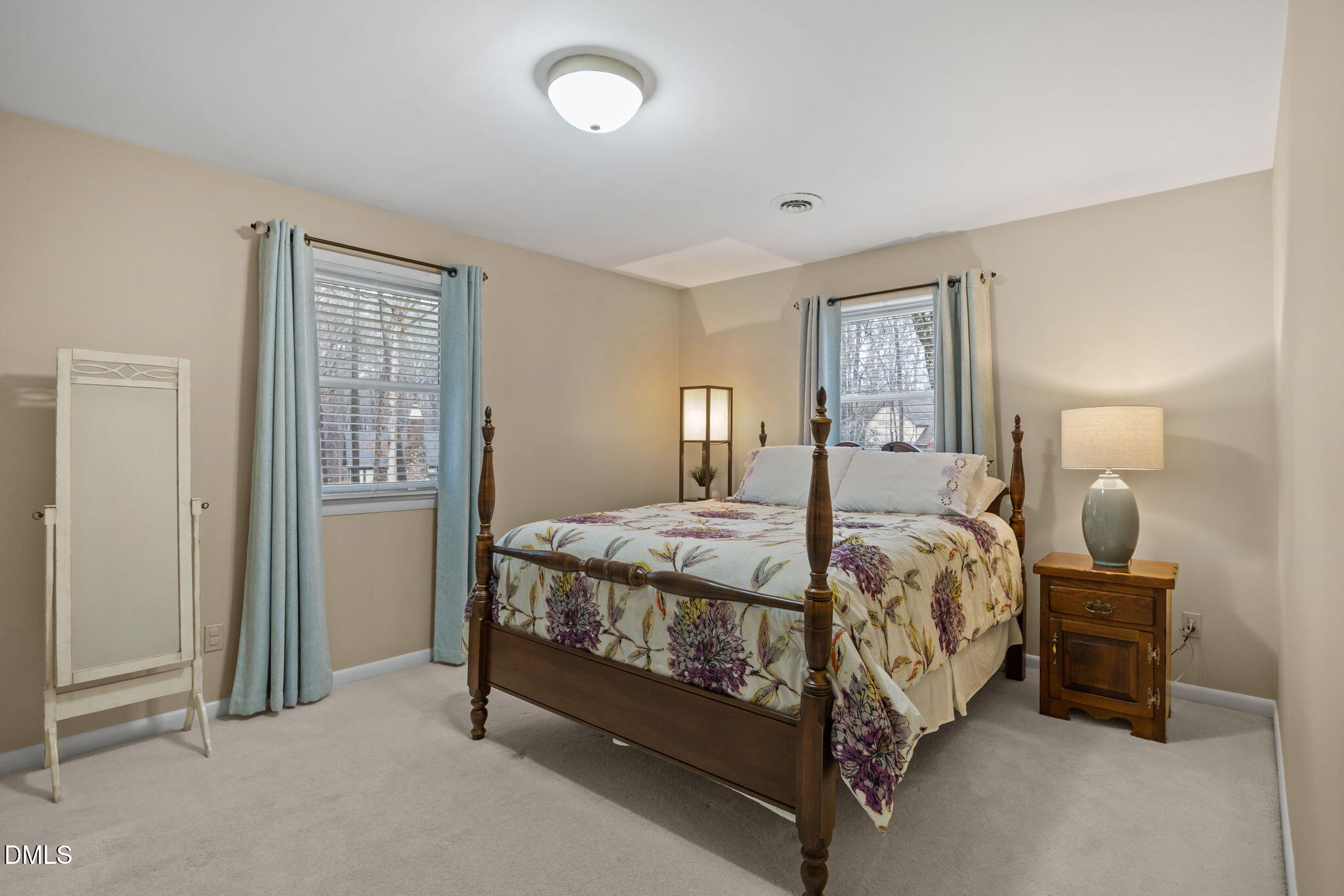 9400 Does Run Court Raleigh, NC 27613 - Photo 21 of 35 a bed sitting in a bedroom next to a lamp