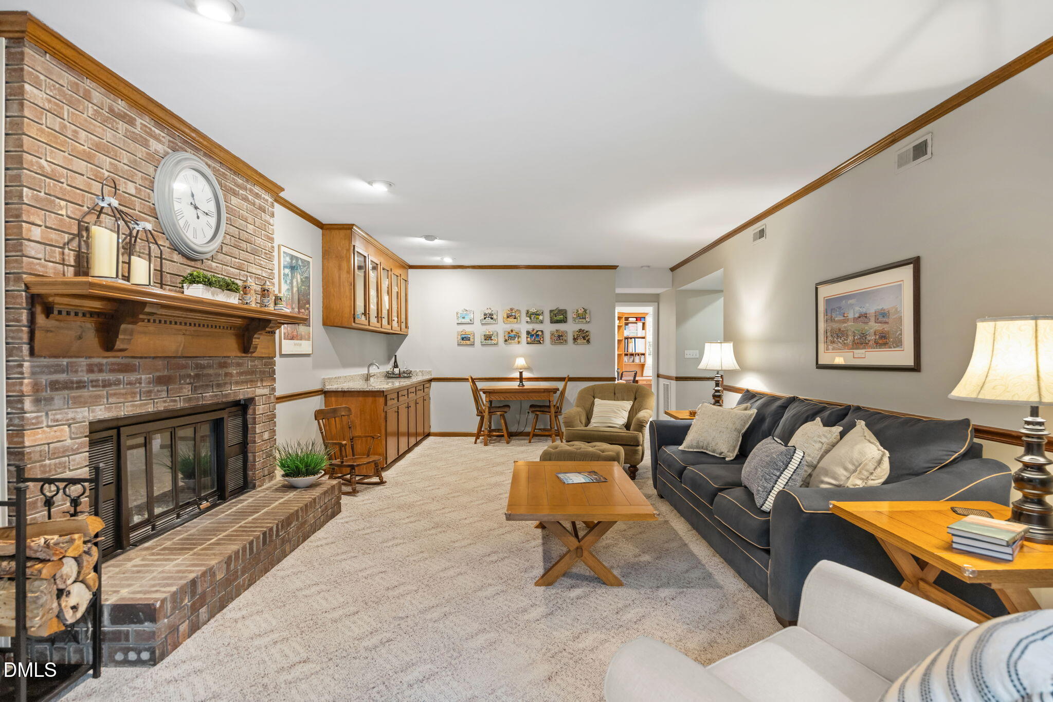 9400 Does Run Court Raleigh, NC 27613 - Photo 26 of 35 a living room with furniture a fireplace and a wall painting