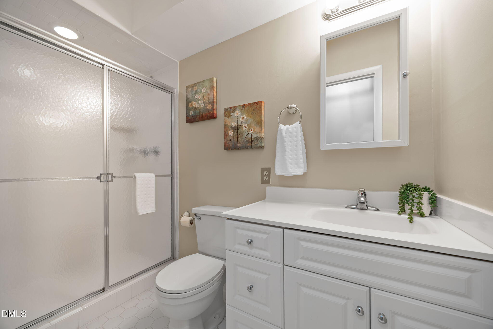 9400 Does Run Court Raleigh, NC 27613 - Photo 29 of 35 a bathroom with a sink toilet vanity and shower