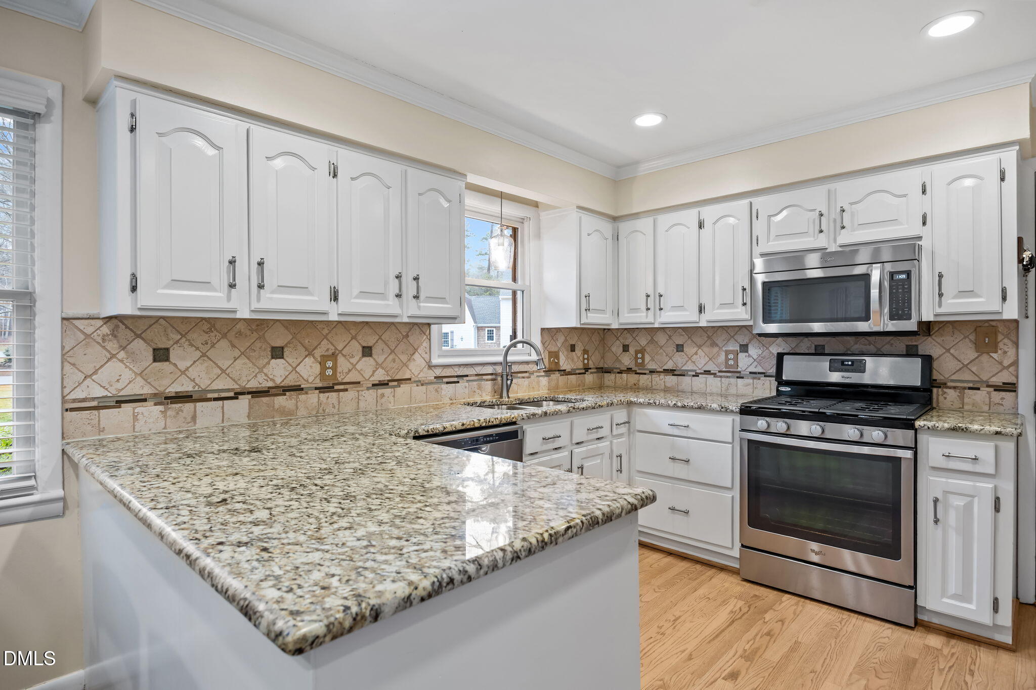 9400 Does Run Court Raleigh, NC 27613 - Photo 6 of 35 a kitchen with a stove a sink and a microwave