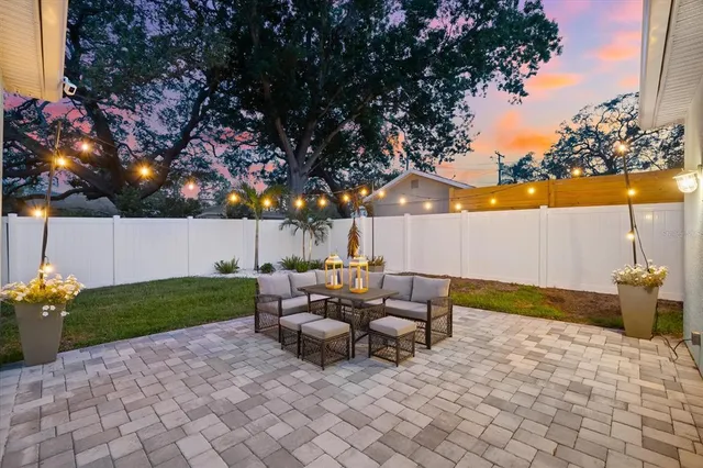 a view of a patio with couches fire pit and a patio