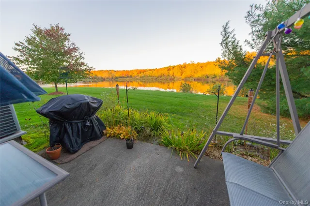 a view of a backyard with a garden and outdoor seating