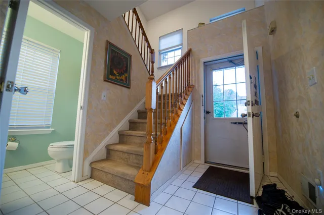 a view of a hallway with wooden floor and stairs