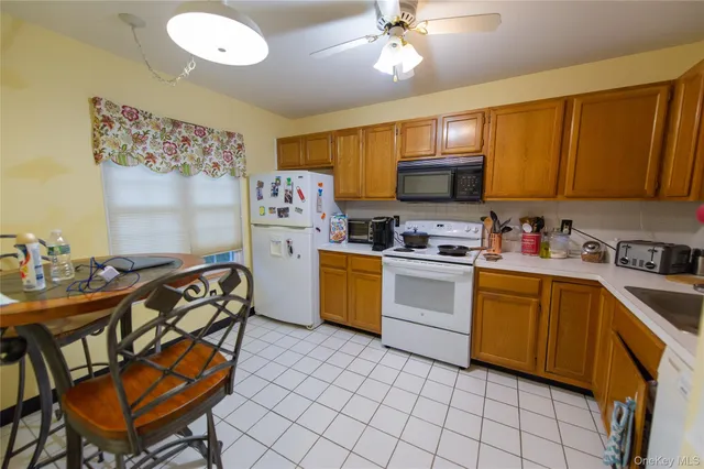 a kitchen with a sink appliances and cabinets