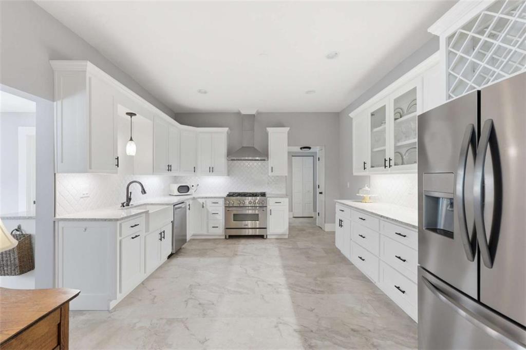 420 Fore Acre Street Cornelia, GA 30531 - Photo 33 of 48 a large white kitchen with stainless steel appliances