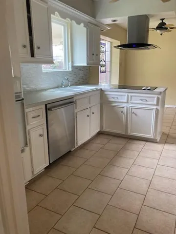 a bathroom with a granite countertop sink a toilet and a mirror