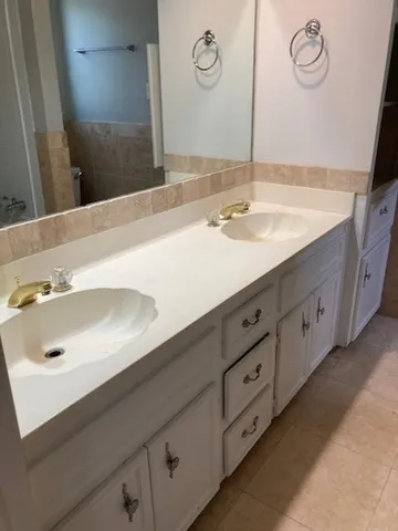 a bathroom with a double vanity sink and a mirror