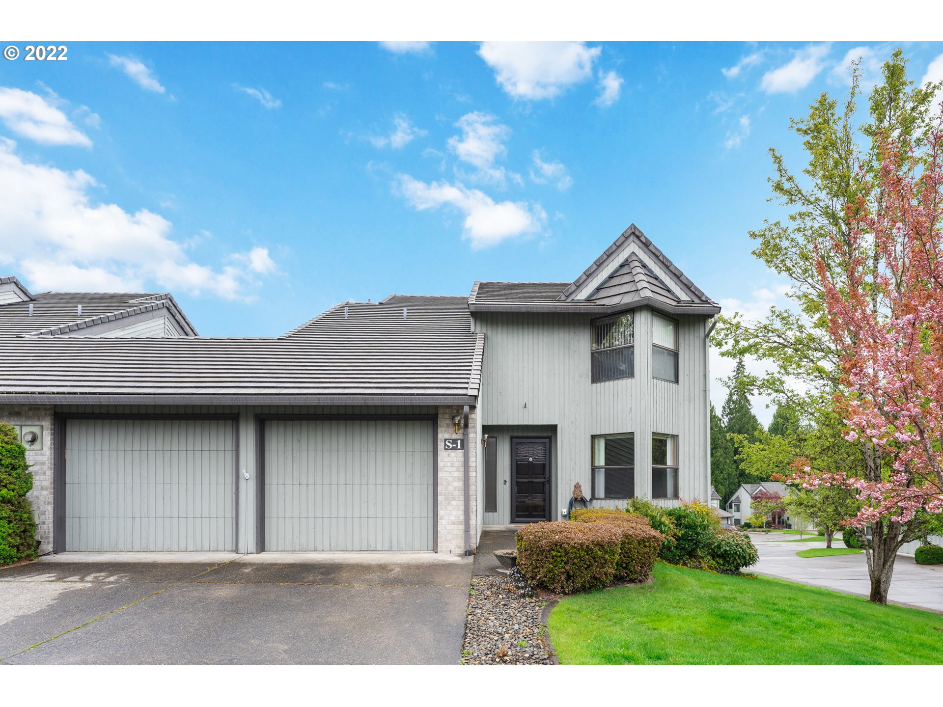 a front view of a house with garden