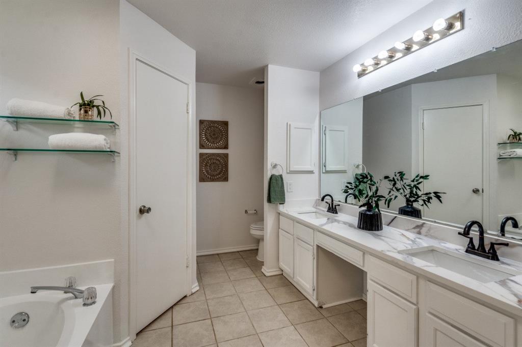 1509 Clover Drive Allen, TX 75002 - Photo 12 of 25 a bathroom with a sink and mirror with toilet