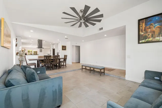 a living room with furniture and kitchen view