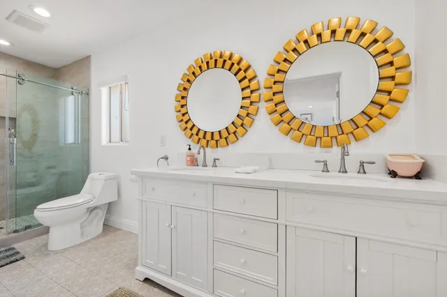 a bathroom with a sink mirror and toilet