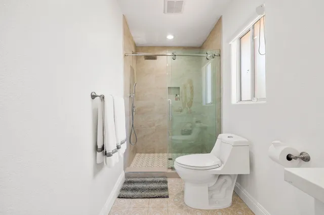 a bathroom with a toilet and a shower