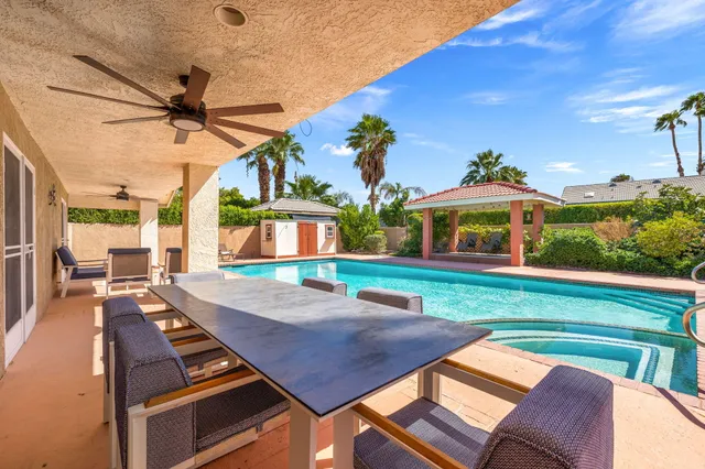a view of a backyard with sitting area