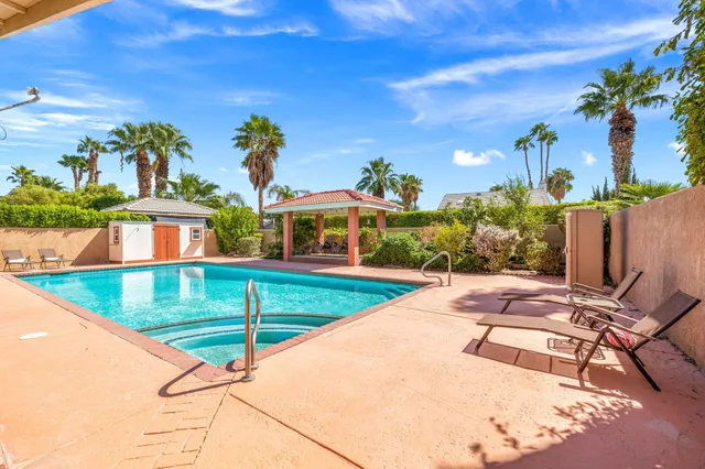 a view of a swimming pool with a lounge chairs