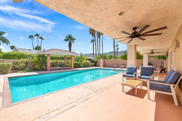 a view of a patio with a table and chairs