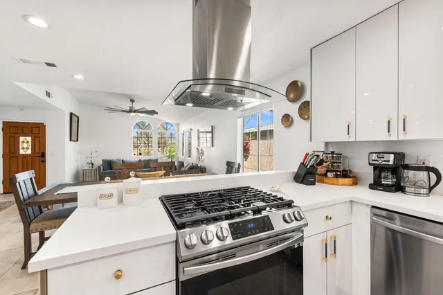 a kitchen with a stove and a white cabinets
