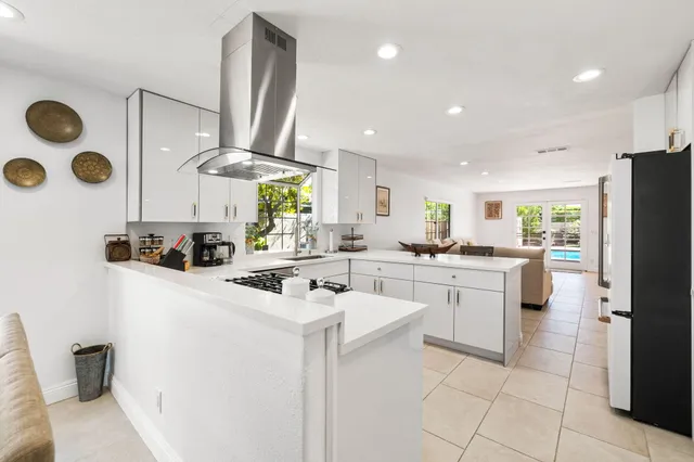 a kitchen with white cabinets and white appliances