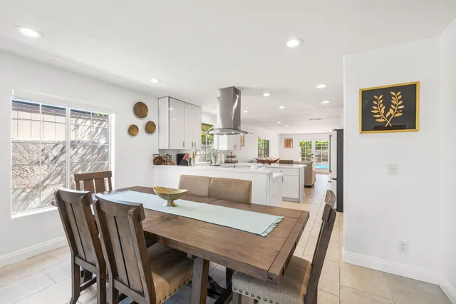 a dining room with furniture and a large window