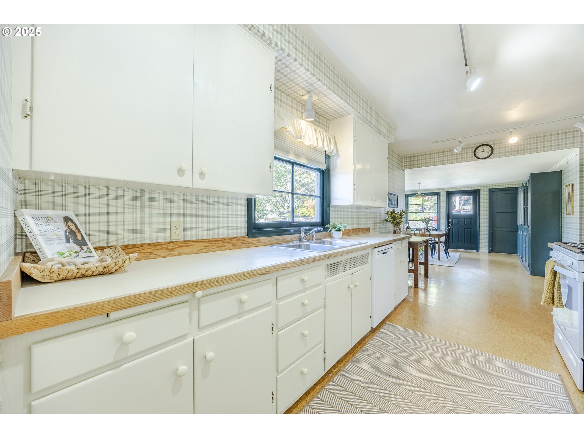 641 City View Boulevard Springfield, OR 97477 - Photo 14 of 48 a open kitchen with kitchen island a sink white cabinets and a wooden floor