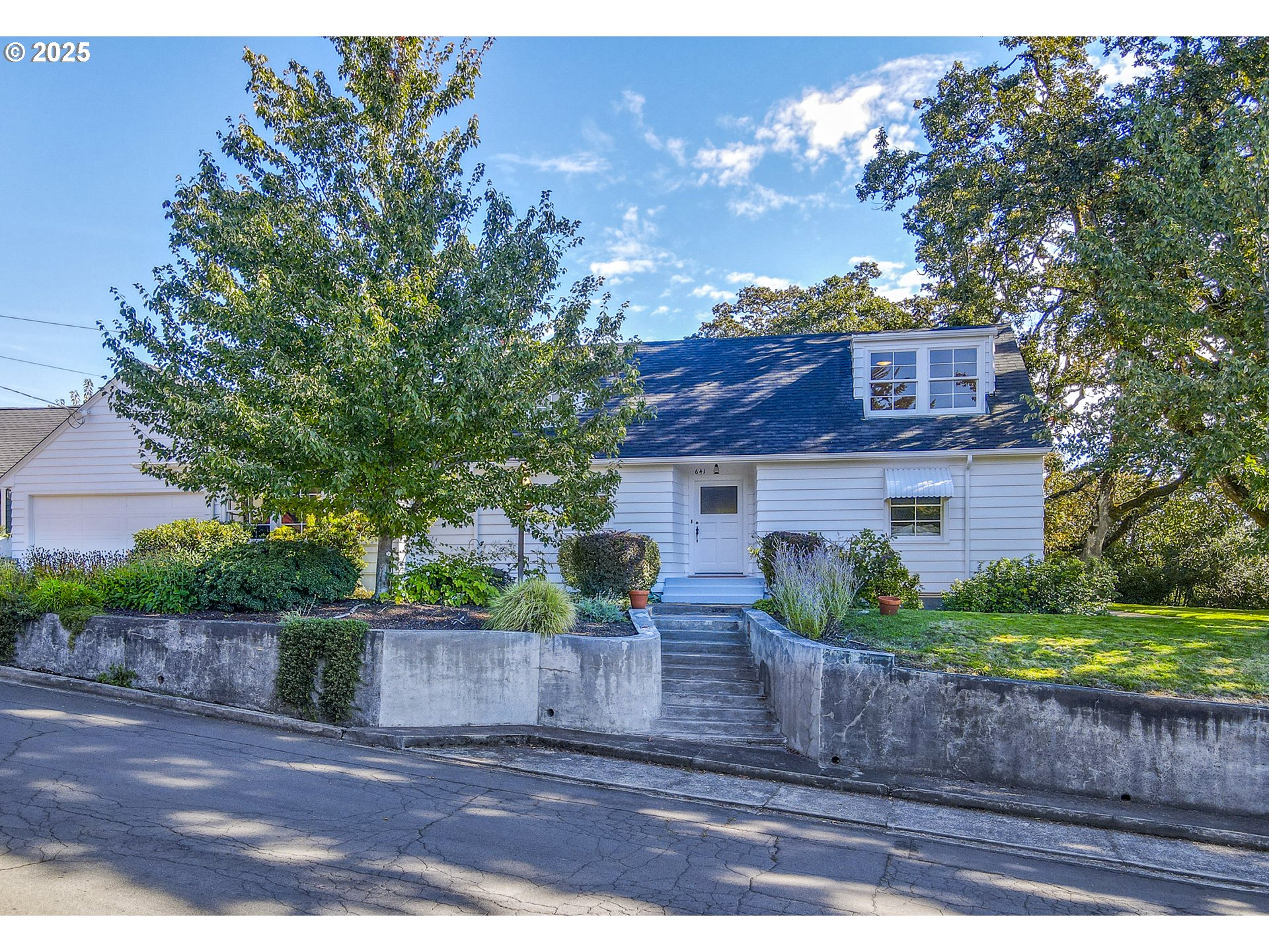 641 City View Boulevard Springfield, OR 97477 - Photo 3 of 48 a view of a brick house next to a yard with large trees