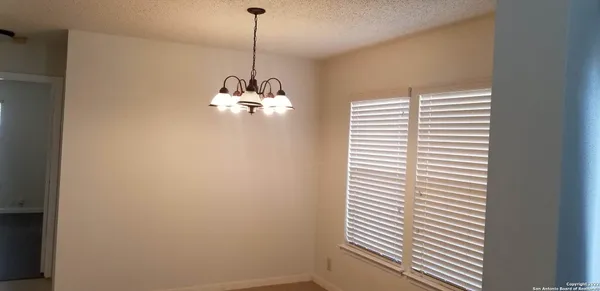 a view of a room with a ceiling fan