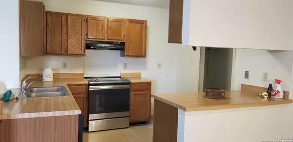 a kitchen with a sink and a stove top oven