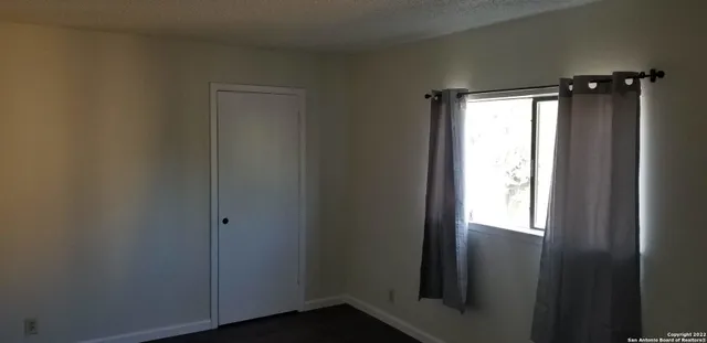 a view of an empty room and a window