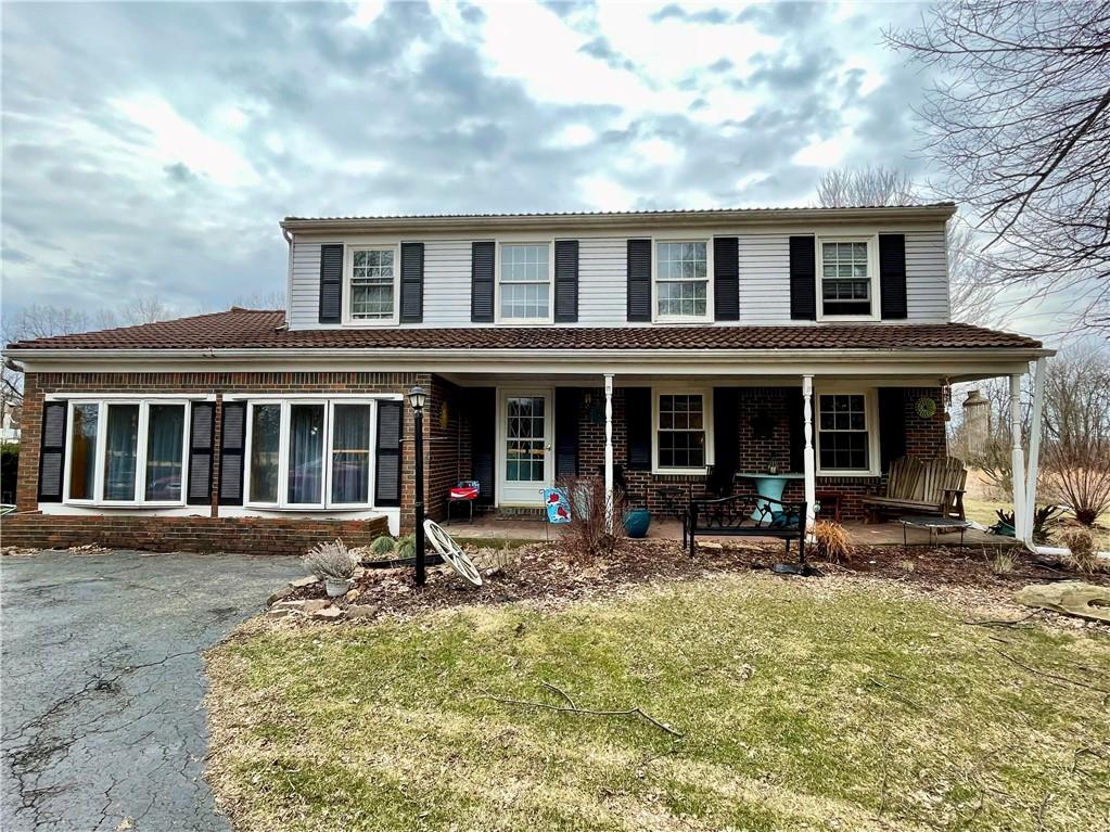 a front view of a house with yard and seating space