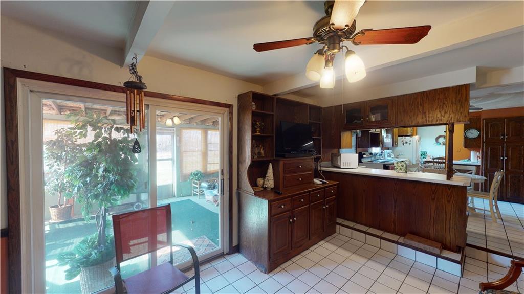 100 Eau Claire Road Boyers, PA 16020 - Photo 14 of 25 a kitchen with stainless steel appliances granite countertop a refrigerator a sink dishwasher a dining table and chairs with wooden floor