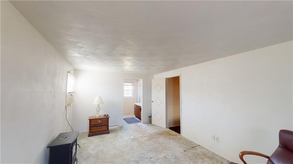 100 Eau Claire Road Boyers, PA 16020 - Photo 17 of 25 an empty room with wooden floor and windows