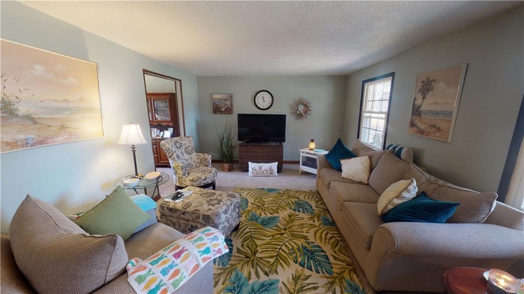 100 Eau Claire Road Boyers, PA 16020 - Photo 4 of 25 a living room with furniture and a fireplace