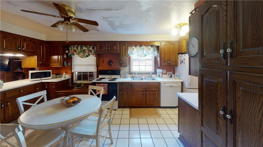 100 Eau Claire Road Boyers, PA 16020 - Photo 6 of 25 a kitchen with a sink a counter top space appliances and cabinets