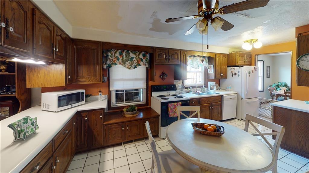 100 Eau Claire Road Boyers, PA 16020 - Photo 7 of 25 a kitchen with stainless steel appliances granite countertop a sink a stove and a refrigerator