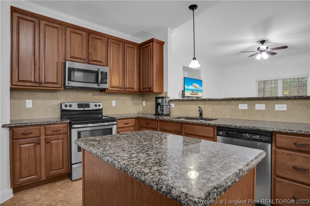 80 Valor Circle Bunnlevel, NC 28323 - Photo 18 of 49 a kitchen with stainless steel appliances granite countertop a stove a sink and a microwave