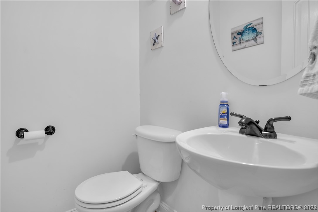 80 Valor Circle Bunnlevel, NC 28323 - Photo 23 of 49 a bathroom with a sink a toilet and a mirror