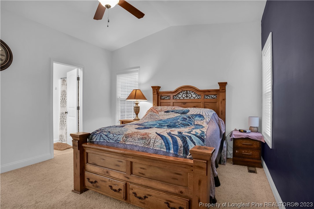 80 Valor Circle Bunnlevel, NC 28323 - Photo 25 of 49 a bedroom with a bed and a chandelier