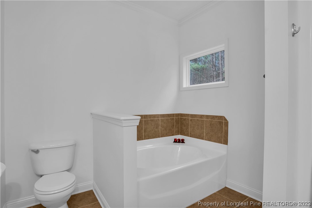 80 Valor Circle Bunnlevel, NC 28323 - Photo 26 of 49 a white bath tub sitting next to a white toilet