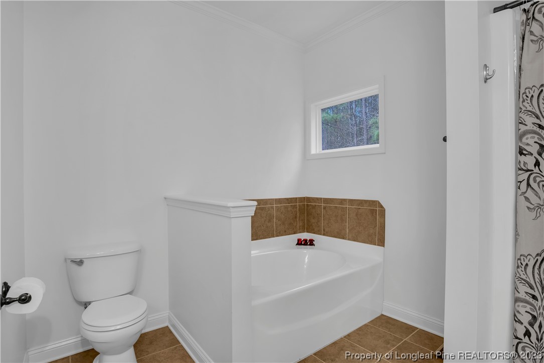 80 Valor Circle Bunnlevel, NC 28323 - Photo 27 of 49 a white bath tub sitting next to a white toilet